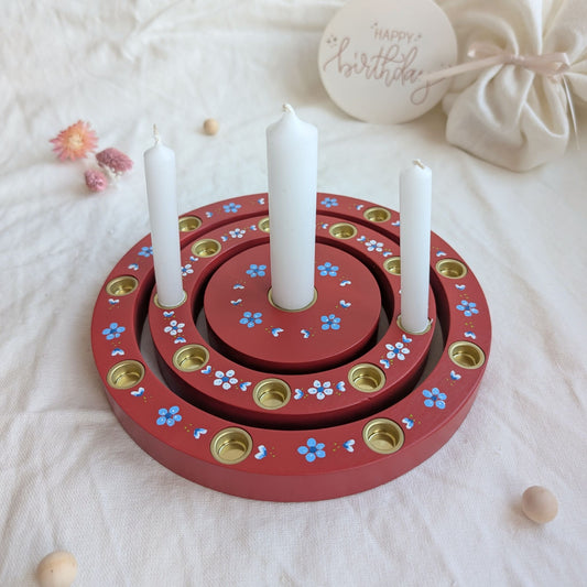 Geburtstagsring aus Holz in Vintage Rot mit Kerzen auf dem Tisch