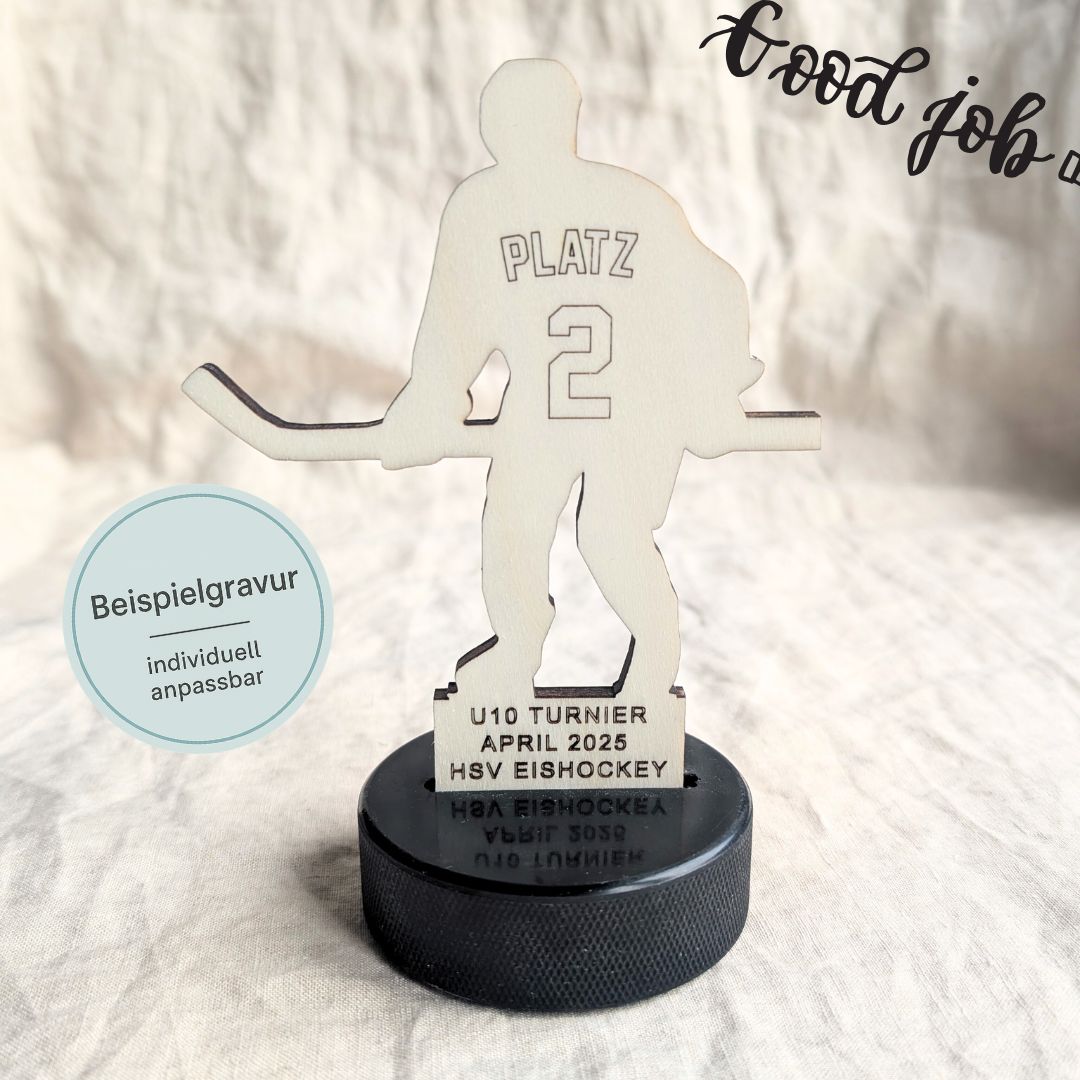 Eishockey Pokal aus Holz, Silhouette eines Eishockeyspielers steht auf einem echten Puck, auf dem Trikot steht Platz 2, am Sockel das Turnier mit Datum des Turniers.